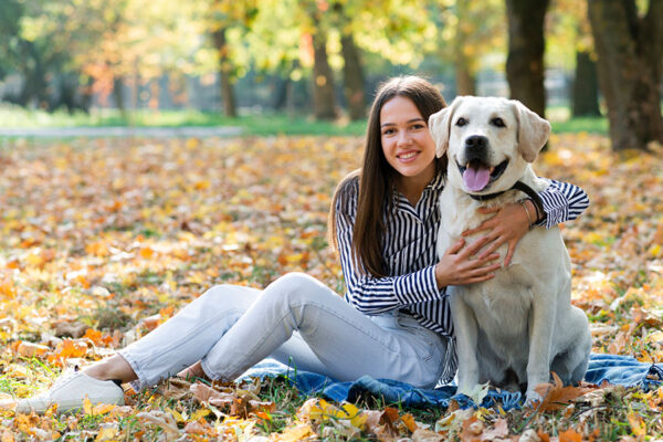 Young woman hugging her adopted rescue dog