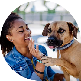 multiracial-girl-sitting-with-her-dog-outside-in multiracial girl sitting with her dog outside in